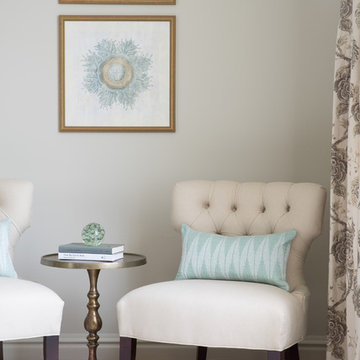 Elegant Sitting Area with Tufted Lounge Chairs and Brass Side Table