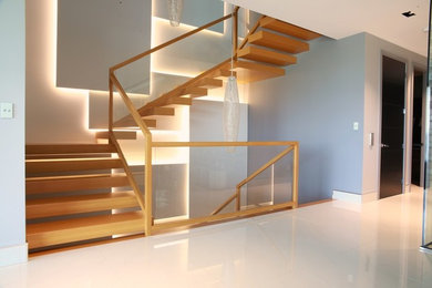 Example of a mid-sized trendy wooden u-shaped staircase design in Other