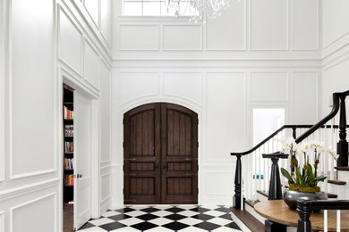 Design ideas for a large eclectic foyer in Minneapolis with white walls, ceramic floors, a double front door, a brown front door and multi-coloured floor.