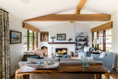 Mid-sized beach style open concept medium tone wood floor living room photo in Orange County with white walls, a standard fireplace, a tile fireplace and a concealed tv
