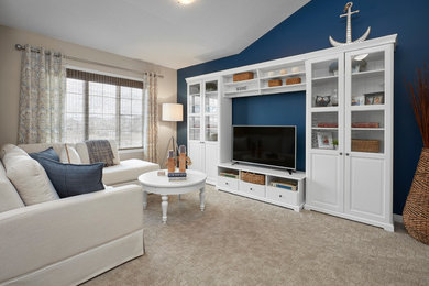 Inspiration for a large transitional loft-style carpeted family room remodel in Edmonton with blue walls and a tv stand