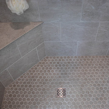 Waypoint Gray Shaker Door Cabinetry with Tiled Shower and Matching Tub Surround