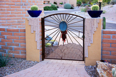 Photo of a mid-sized front yard full sun xeriscape in Phoenix with a garden path and brick pavers.