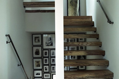 Example of a mid-sized mountain style wooden u-shaped open staircase design in Houston