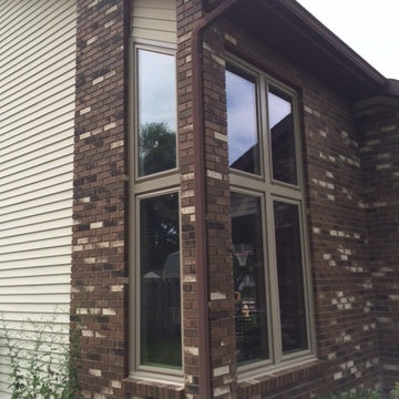 Vinyl replacement windows in brick wall - after