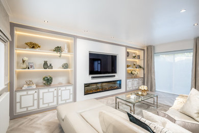 Living room - mid-sized modern enclosed vinyl floor and gray floor living room idea in Hertfordshire with white walls, a standard fireplace, a plaster fireplace and a media wall
