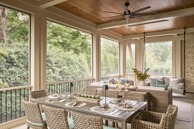 Large transitional screened-in back porch photo in Charlotte with a roof extension
