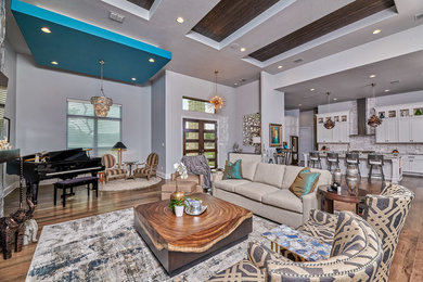 Living room - mid-sized modern formal and open concept medium tone wood floor and brown floor living room idea in Other with gray walls, a standard fireplace and a wall-mounted tv