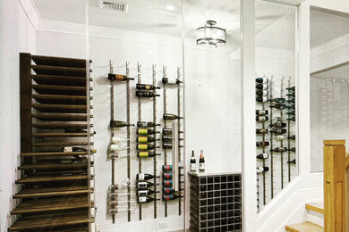 Inspiration for a small modern gray floor wine cellar remodel in New York with storage racks