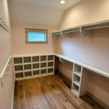 Elegant Guest Closet Organization: White Built-Ins, Open Cubbies, and Hanging St