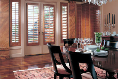 Inspiration for a large timeless dark wood floor and brown floor enclosed dining room remodel in Orange County with beige walls and no fireplace