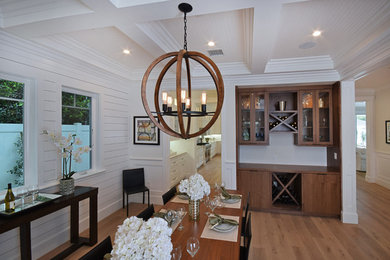 Photo of a mid-sized country kitchen/dining combo in DC Metro with white walls, light hardwood floors and no fireplace.