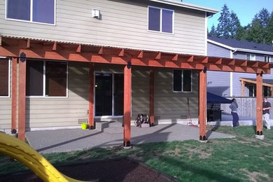 Inspiration for a large timeless backyard patio remodel in Seattle with a pergola