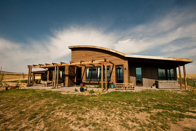 Inspiration for a mid-sized rustic brown one-story mixed siding house exterior remodel in Other