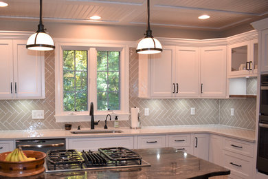 Large transitional u-shaped medium tone wood floor eat-in kitchen photo in Boston with shaker cabinets, white cabinets, quartzite countertops, gray backsplash, an island and white countertops