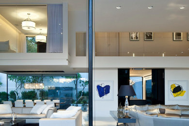 Example of a huge minimalist open concept white floor and wall paneling living room design in Miami with white walls