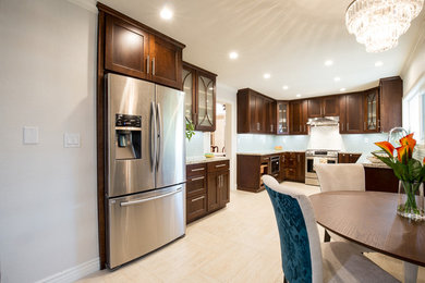 Open concept kitchen - mid-sized transitional u-shaped porcelain tile open concept kitchen idea in San Francisco with a double-bowl sink, shaker cabinets, dark wood cabinets, granite countertops, blue backsplash, porcelain backsplash, stainless steel appliances and no island