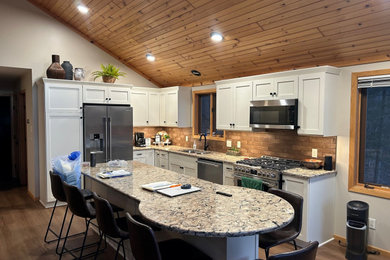 Eat-in kitchen - mid-sized modern l-shaped eat-in kitchen idea in Other with white cabinets, quartz countertops and an island
