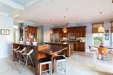 Example of a trendy kitchen design in Houston with granite countertops, cement tile backsplash, stainless steel appliances and an island