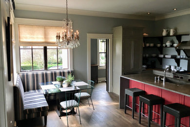 Example of a mid-sized minimalist eat-in kitchen design in DC Metro with an island