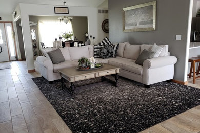 Example of a mid-sized transitional formal and open concept light wood floor and beige floor living room design in St Louis with gray walls, no fireplace and no tv