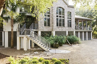 Inspiration for an eclectic two-story brick exterior home remodel in Charleston