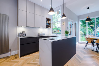 Inspiration for a medium sized modern u-shaped open plan kitchen in Manchester with an integrated sink, quartz worktops and stainless steel appliances.
