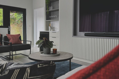 Inspiration for a large modern single-wall dry bar in West Midlands with no sink, recessed-panel cabinets, grey cabinets, quartz worktops, white splashback, stone slab splashback, laminate floors, beige floors, white worktops and a feature wall.