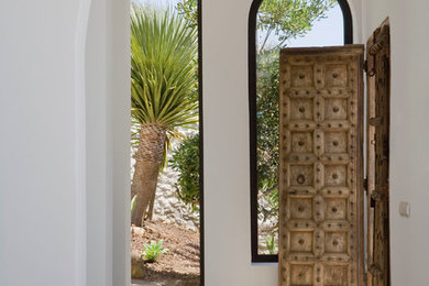 Photo of a mid-sized mediterranean hallway in Malaga with white walls.