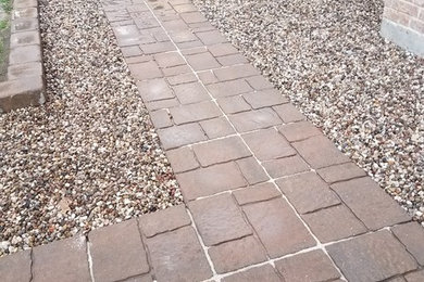 This is an example of a mid-sized traditional front yard concrete paver landscaping in Houston.