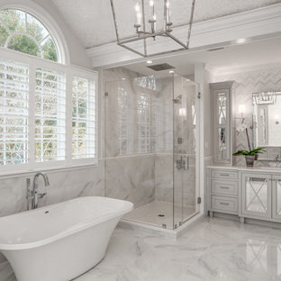 Bathroom - large transitional master white tile and marble tile marble floor bathroom idea in DC Metro with glass-front cabinets, gray cabinets, marble countertops, white walls and an undermount sink