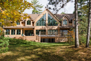Mid-sized country three-storey exterior in Toronto with wood siding.