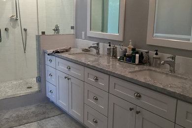 Inspiration for a large transitional master white tile and ceramic tile marble floor corner shower remodel in San Francisco with an undermount sink, shaker cabinets, white cabinets, marble countertops, an undermount tub, a one-piece toilet and gray walls