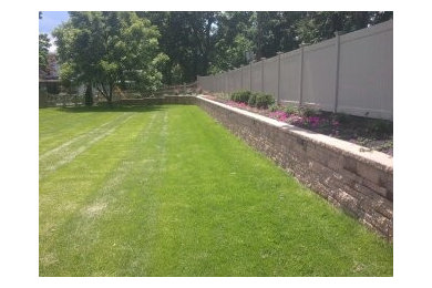 Design ideas for a large traditional partial sun hillside mulch retaining wall landscape in Philadelphia for spring.
