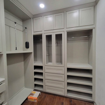 Custom Walk-In Closet with Glass-Front Cabinets & Pull-Down Storage
