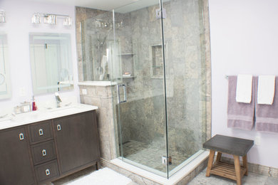 Inspiration for a large transitional master multicolored tile and porcelain tile porcelain tile and multicolored floor corner shower remodel in Other with dark wood cabinets, gray walls and a hinged shower door