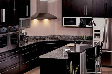 Large elegant l-shaped ceramic tile eat-in kitchen photo in Miami with a drop-in sink, flat-panel cabinets, dark wood cabinets, granite countertops, stainless steel appliances and an island