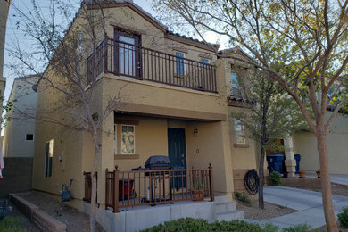 Example of a mid-sized classic beige two-story stucco house exterior design in Las Vegas