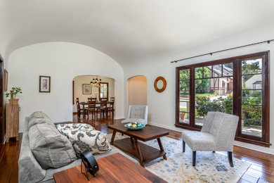 Living room - mid-sized french country formal medium tone wood floor living room idea in Los Angeles with a standard fireplace and a tile fireplace