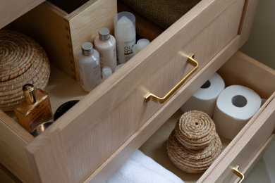 Example of a small trendy ceramic tile and beige floor powder room design in Toronto with shaker cabinets, light wood cabinets, a two-piece toilet, green walls, an undermount sink, quartz countertops, white countertops and a freestanding vanity