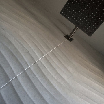 modern rain shower at dimensional wall tile