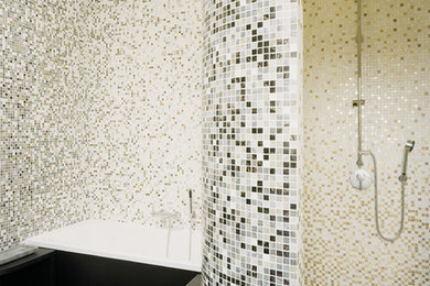 Photo of a mid-sized contemporary bathroom in Bremen with a drop-in tub, an alcove shower, beige tile, gray tile, black tile, white tile, mosaic tile and dark hardwood floors.