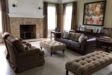 Large elegant medium tone wood floor and brown floor living room photo in Philadelphia with beige walls, a standard fireplace, a stone fireplace and no tv