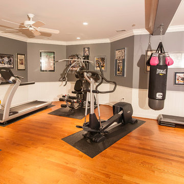 Home gym with large mirror and bright lighting