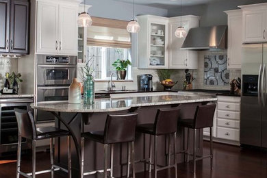 Eat-in kitchen - mid-sized transitional l-shaped dark wood floor and brown floor eat-in kitchen idea in Portland with an undermount sink, raised-panel cabinets, white cabinets, granite countertops, white backsplash, porcelain backsplash, stainless steel appliances and an island