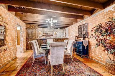 Large southwest terra-cotta tile and orange floor enclosed dining room photo in Phoenix with brown walls and no fireplace