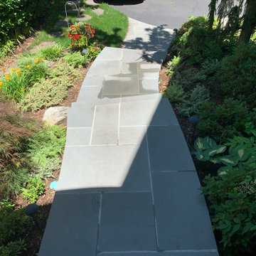 Walkway, retaining walls, plantings and stone stairs and front stoop
