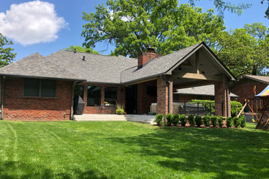 Large transitional backyard concrete patio photo in Other with a fire pit and a roof extension