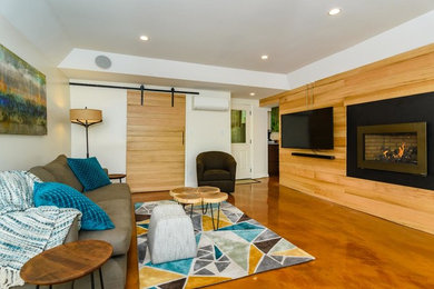 Mid-sized transitional open concept concrete floor and beige floor living room photo in Other with white walls, a ribbon fireplace, a metal fireplace and a wall-mounted tv