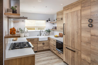 Eat-in kitchen - small coastal u-shaped laminate floor and white floor eat-in kitchen idea in San Diego with flat-panel cabinets, light wood cabinets, quartz countertops, white backsplash, quartz backsplash, colored appliances, white countertops, an undermount sink and no island
